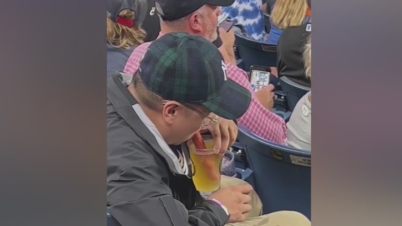 Man uses hot dog as a beer straw at baseball game in viral video